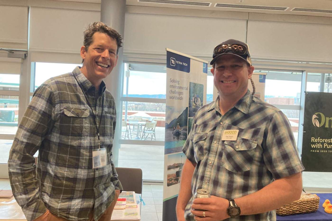 2 attendees smiling at poster session