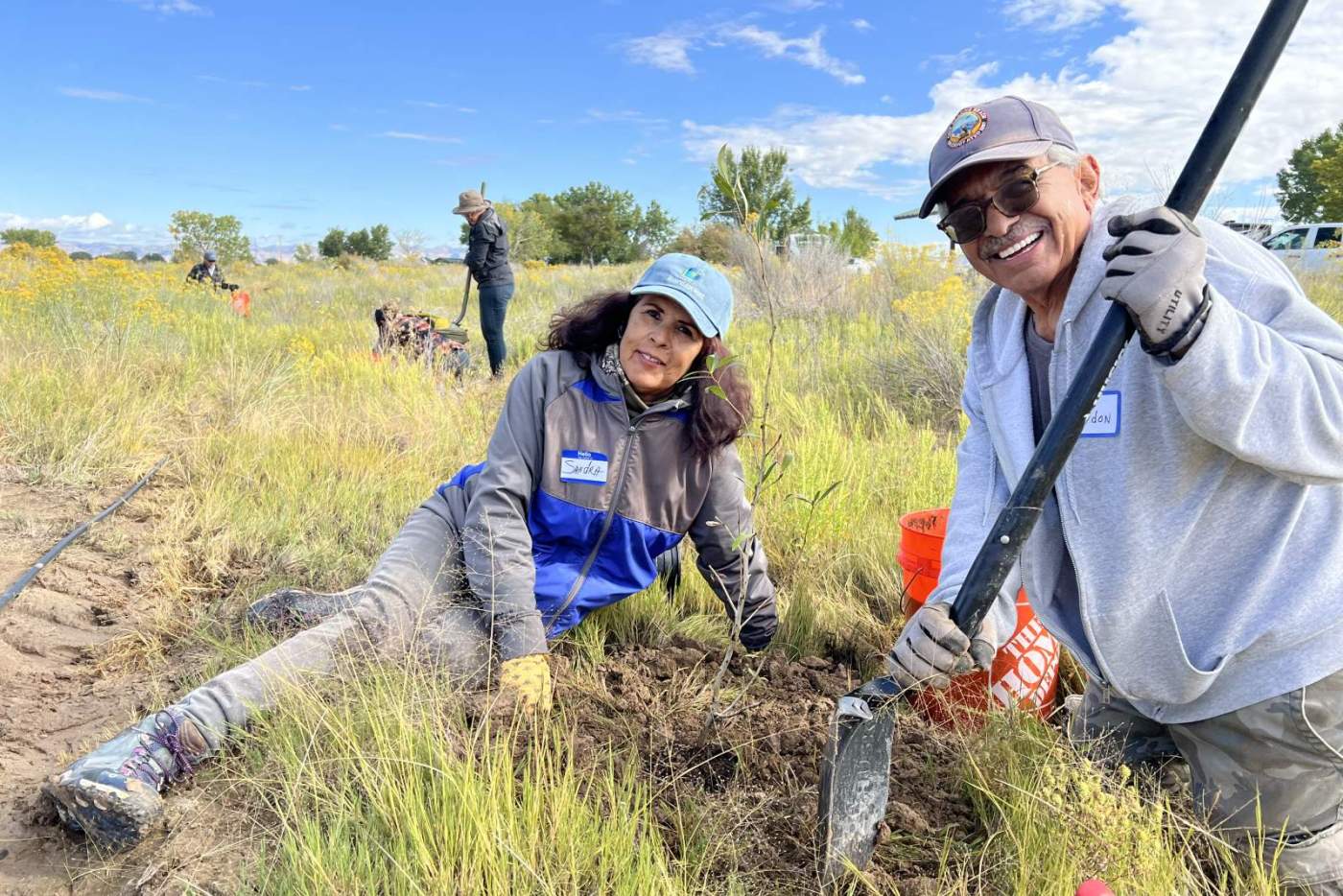 2 Volunteers planting native plant