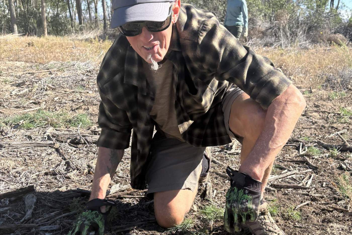volunteer from amazon pulls weeds