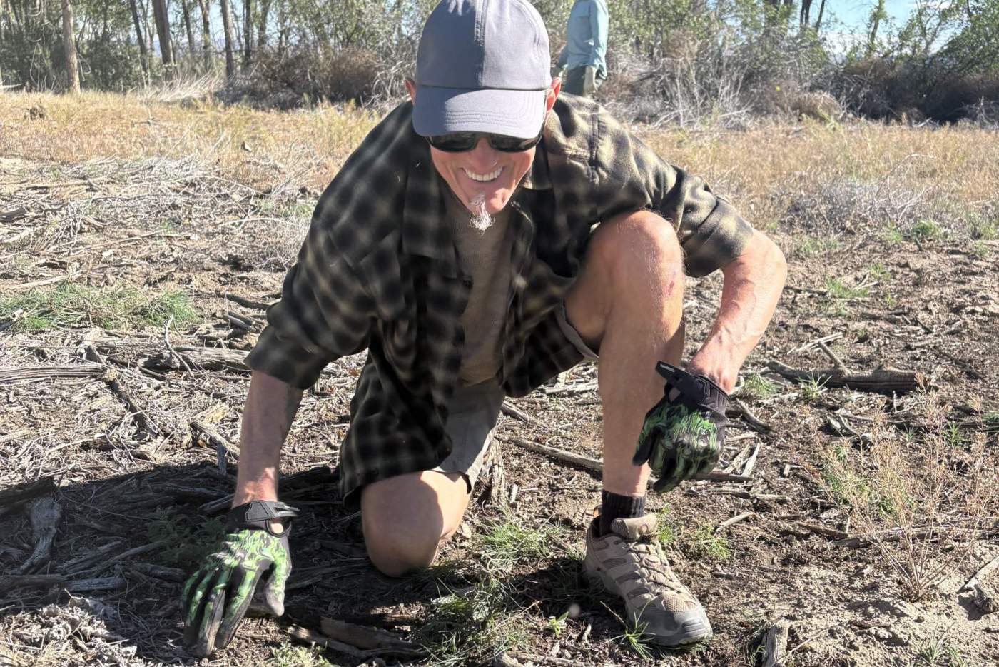 volunteer from amazon pulls weeds