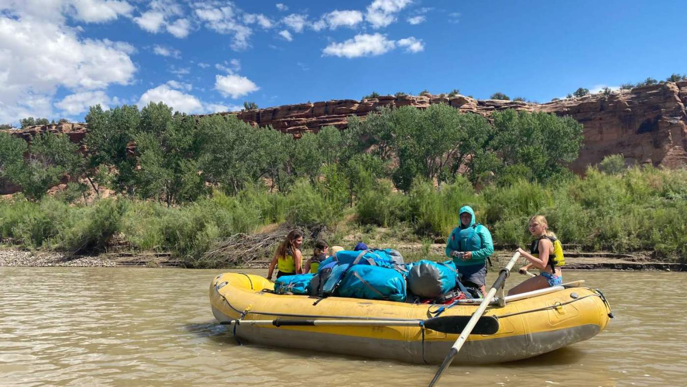 group of people in raft on the river