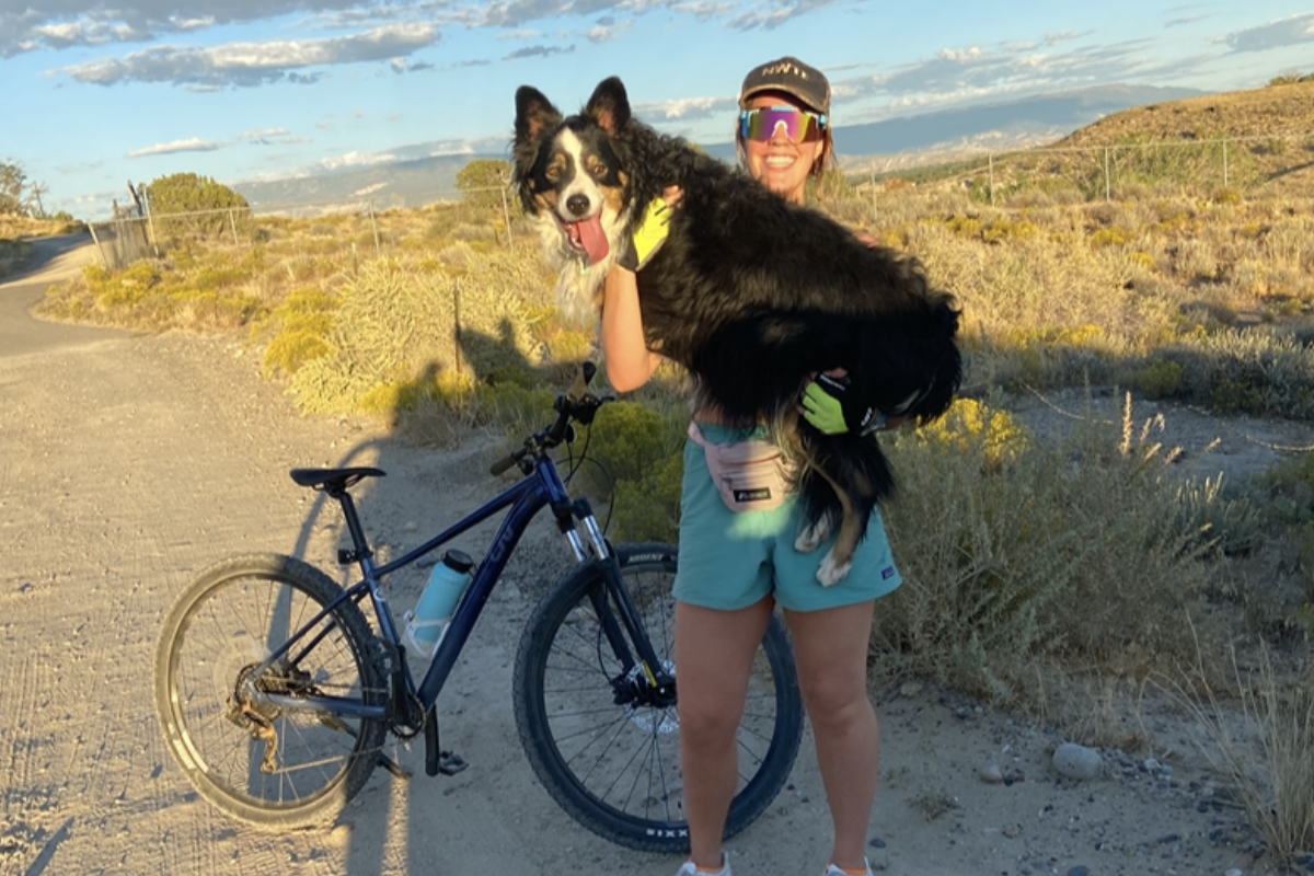 Carissa Crawford with border collie and bike